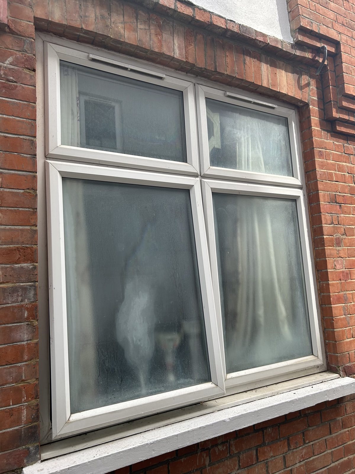 Blown double glazing replaced — before, Surrey